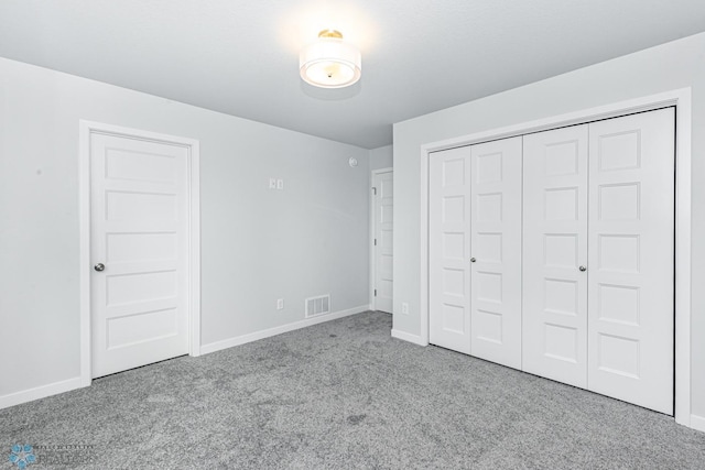 unfurnished bedroom with light carpet and a closet