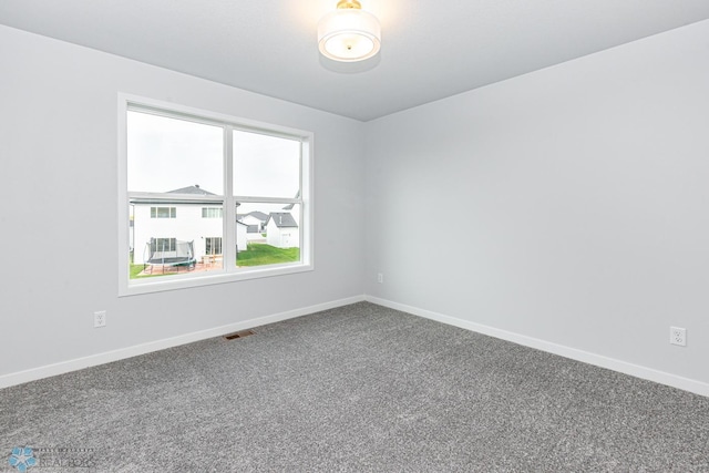 empty room with carpet flooring and baseboards