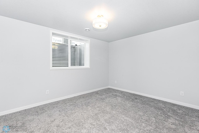 carpeted spare room with baseboards