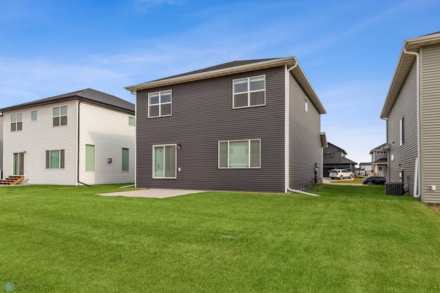 rear view of property featuring a yard, a patio, and central AC unit