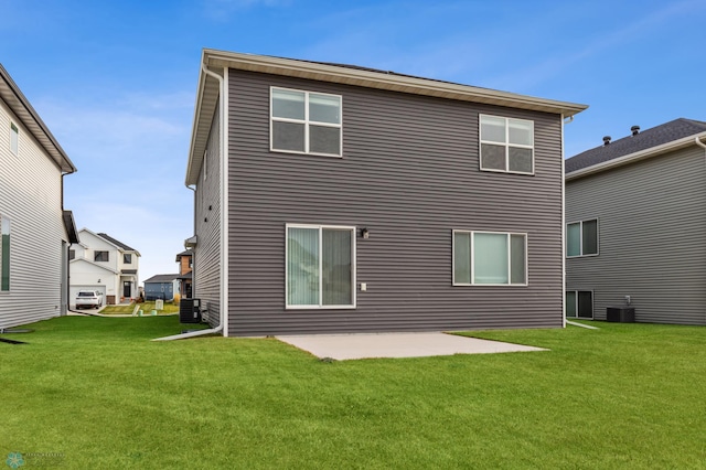 back of property with a lawn and a patio area