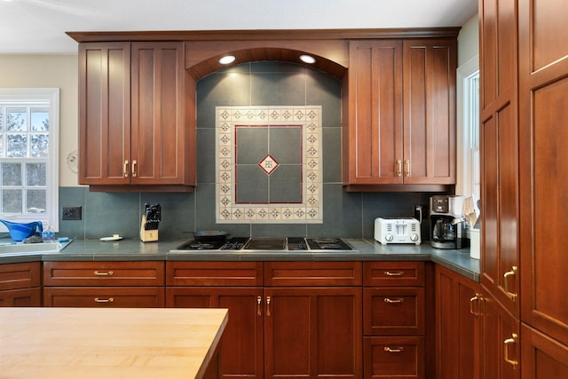 kitchen featuring stainless steel gas cooktop and decorative backsplash