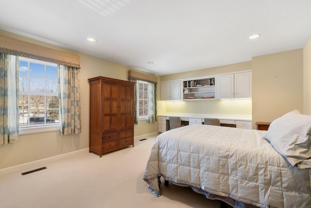 bedroom with light carpet, recessed lighting, visible vents, and baseboards