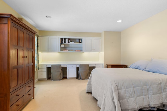 bedroom featuring built in desk, recessed lighting, and light colored carpet