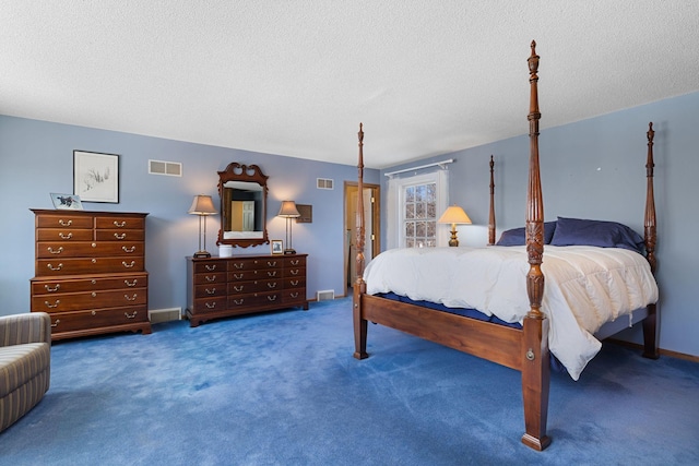 bedroom with a textured ceiling, carpet flooring, visible vents, and baseboards