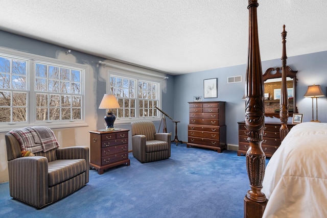 carpeted bedroom with visible vents and a textured ceiling