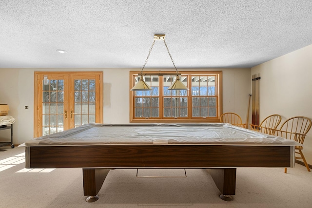 game room with light carpet, french doors, a textured ceiling, and billiards