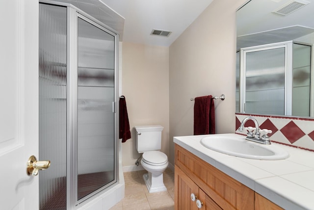 bathroom featuring toilet, vanity, visible vents, and tile patterned floors