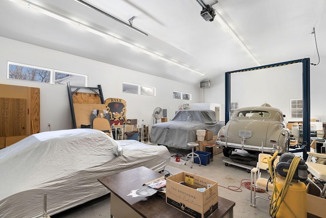 bedroom featuring concrete flooring, lofted ceiling, and a garage