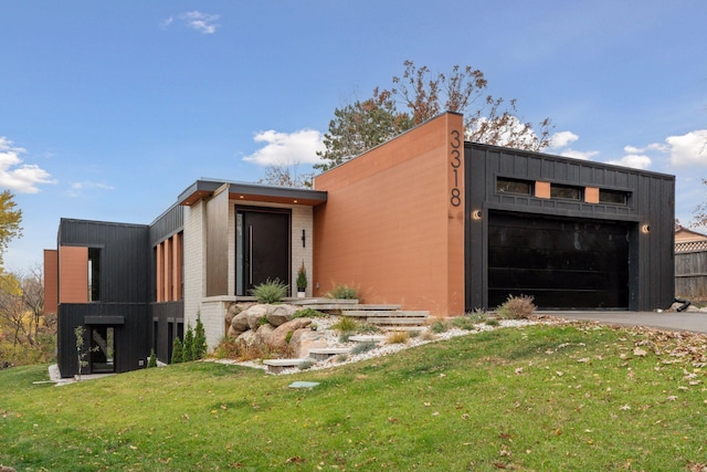 view of front of home with a front yard and a garage