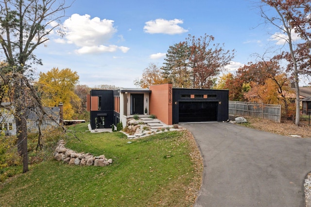 contemporary home with a front yard and a garage