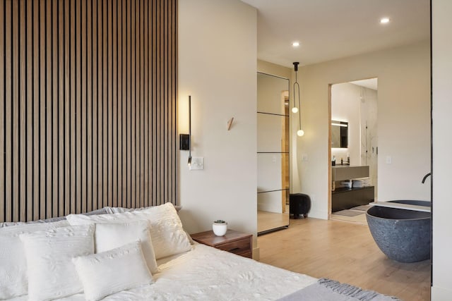 bedroom featuring sink and light hardwood / wood-style flooring