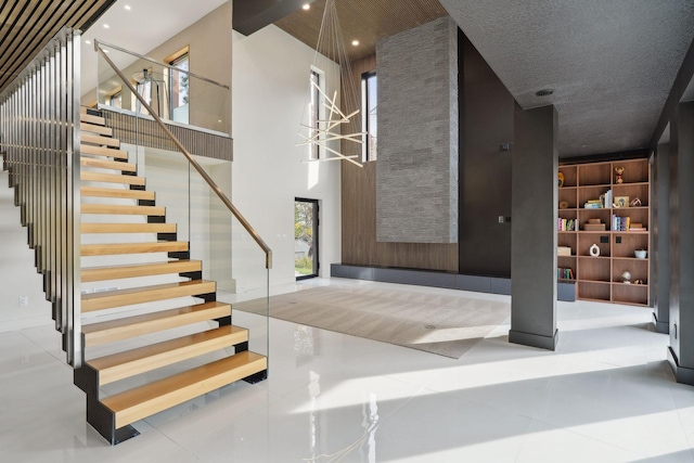 staircase featuring tile patterned floors and a textured ceiling