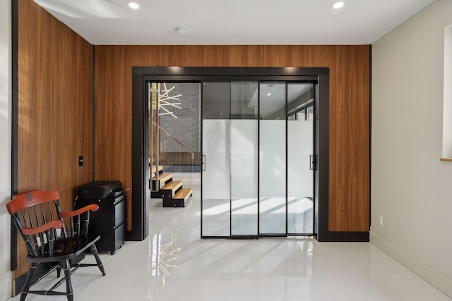 doorway with wooden walls and plenty of natural light