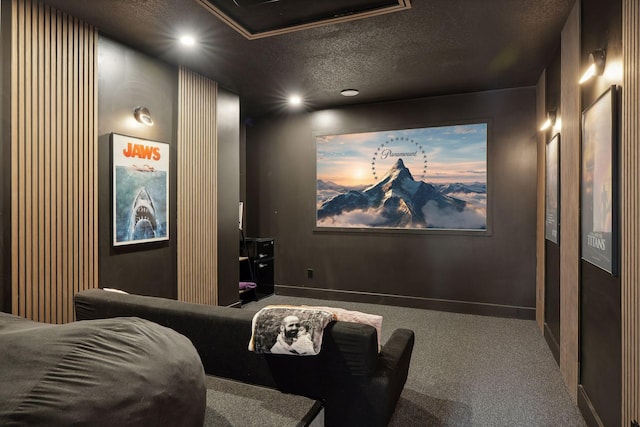 carpeted cinema with ornate columns and a textured ceiling