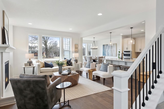 living room featuring a notable chandelier and dark hardwood / wood-style flooring