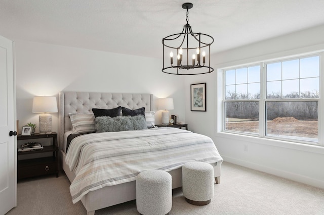 carpeted bedroom with a notable chandelier