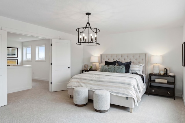 bedroom featuring a notable chandelier and light colored carpet