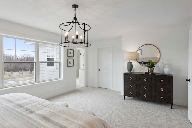 carpeted bedroom featuring a chandelier