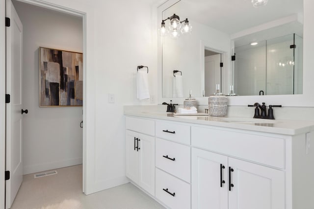 bathroom featuring vanity and a shower with shower door