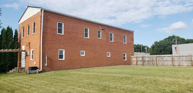 view of side of home with a lawn