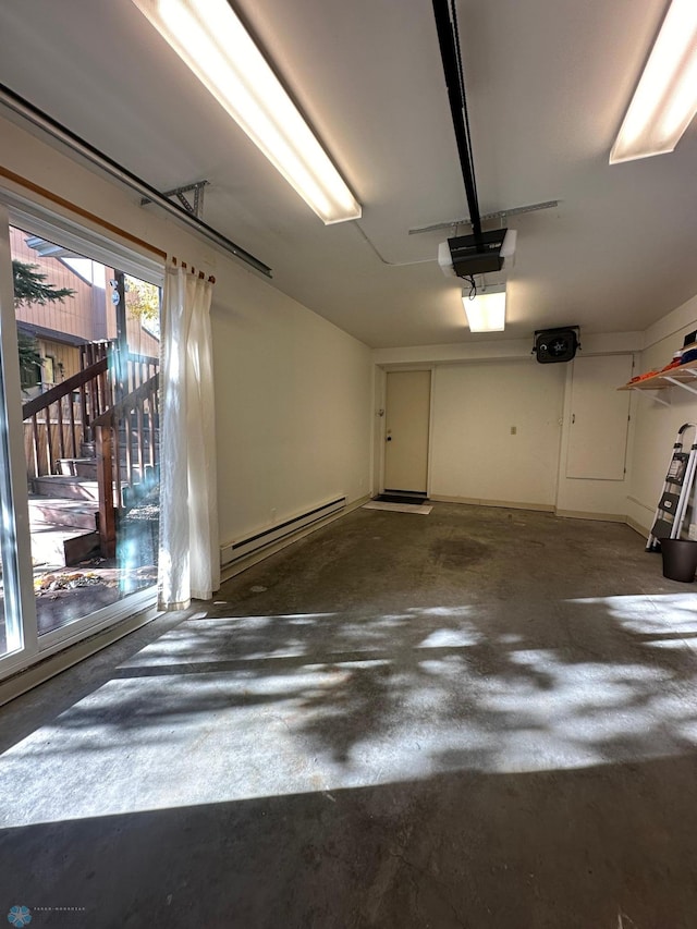 garage featuring a garage door opener and a baseboard radiator