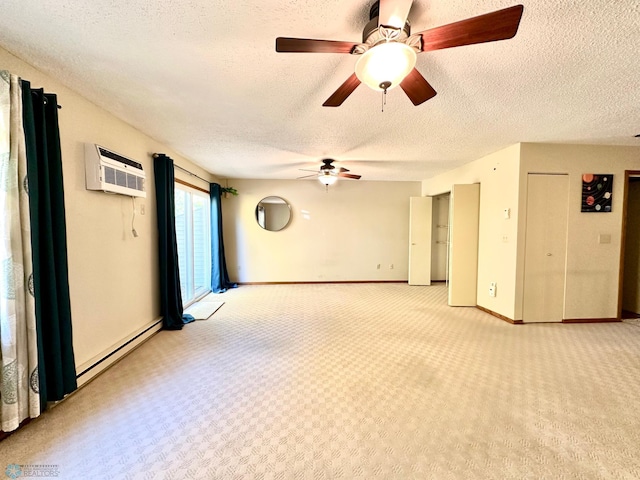 empty room featuring light carpet, a wall mounted AC, a textured ceiling, and baseboard heating