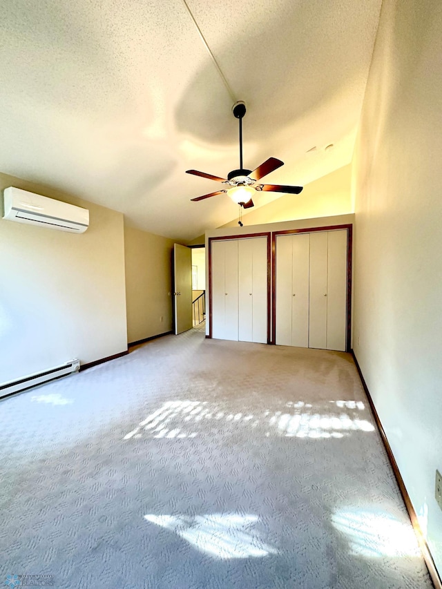 unfurnished bedroom featuring vaulted ceiling, an AC wall unit, a baseboard radiator, carpet, and ceiling fan