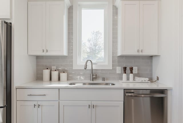 kitchen with white cabinetry, sink, and appliances with stainless steel finishes