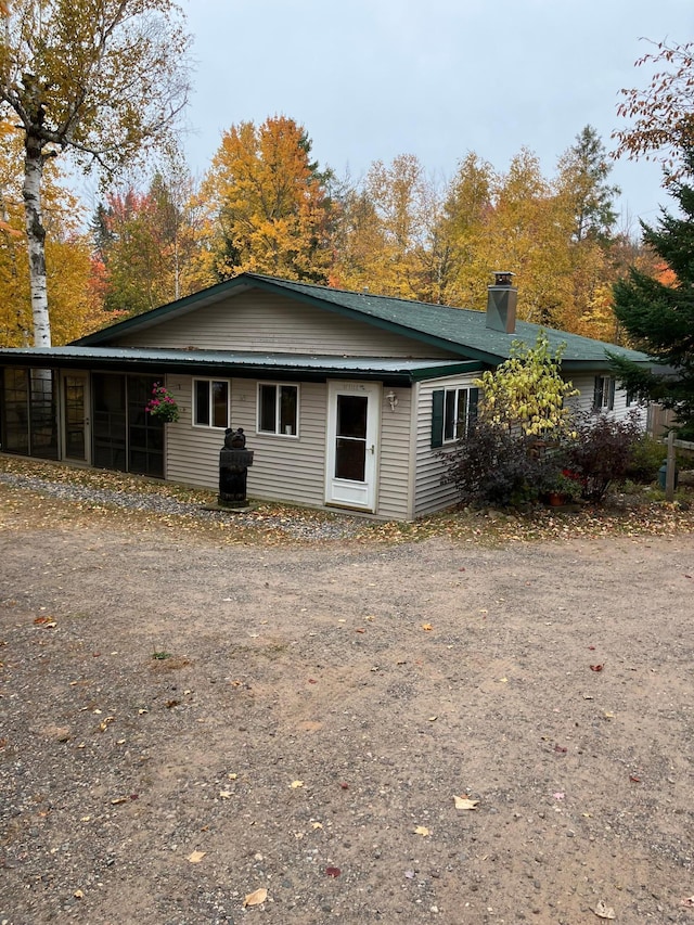 back of property with a sunroom