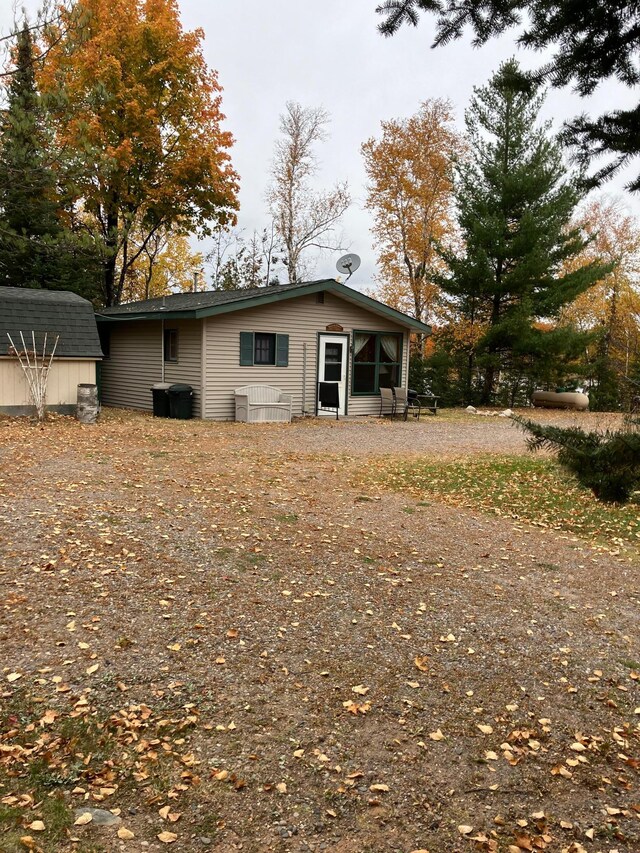 view of property exterior with a storage unit