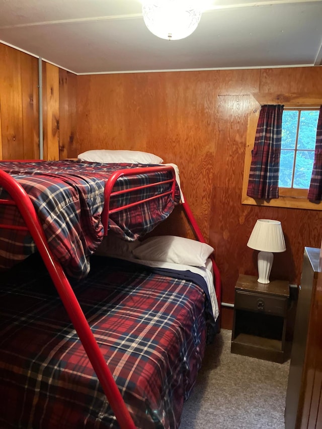 carpeted bedroom with wood walls