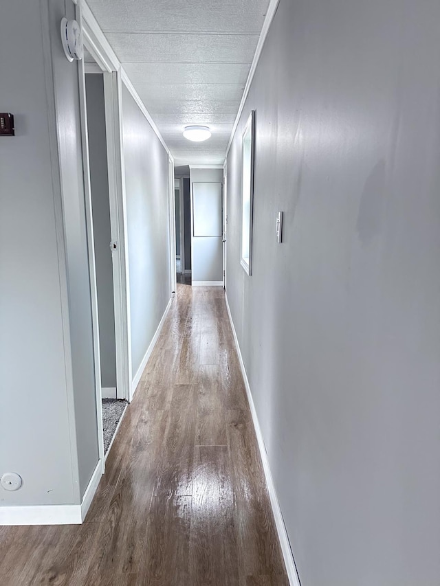 hallway featuring crown molding and hardwood / wood-style flooring