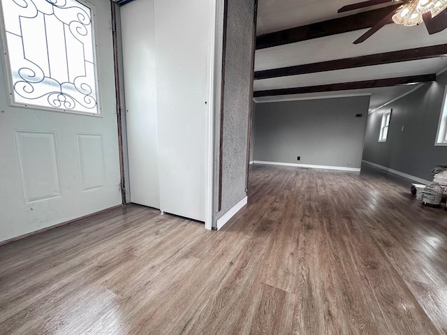 entrance foyer with beam ceiling, wood-type flooring, and ceiling fan