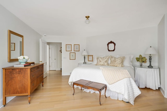 bedroom featuring light wood-style floors and baseboards