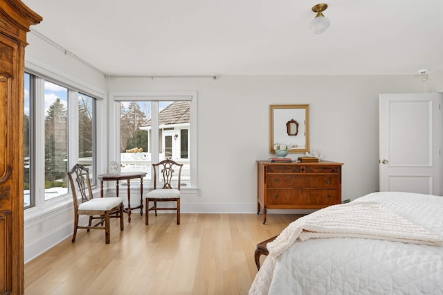 bedroom featuring baseboards and light wood-style floors