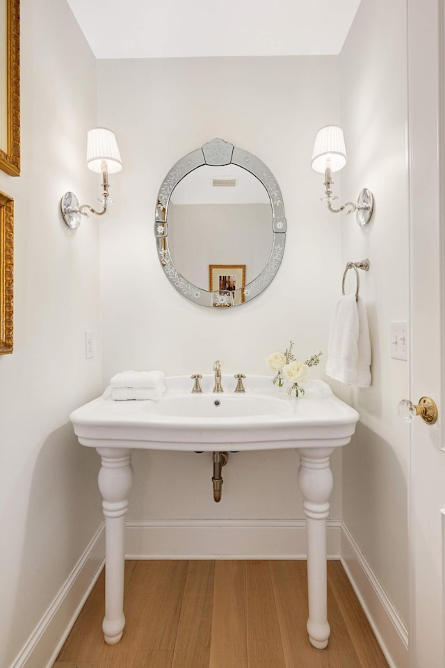 bathroom featuring baseboards and wood finished floors