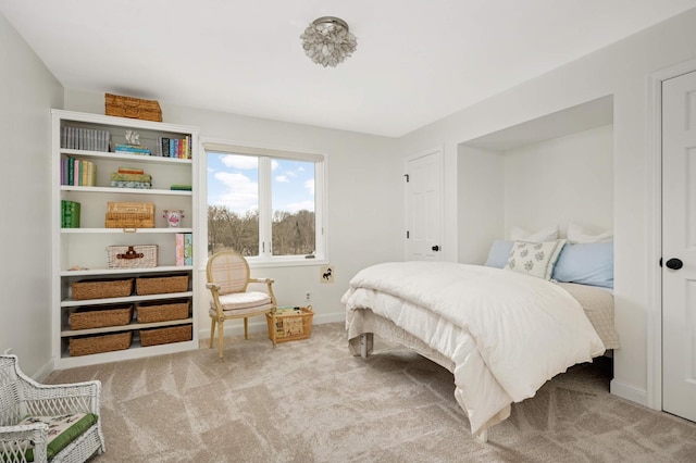 bedroom featuring carpet and baseboards