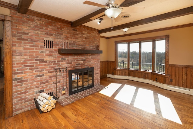 2700 115th St NW, Oronoco, MN 55960 - unfurnished living room with wood finished floors, beam ceiling, and a wainscoted wall