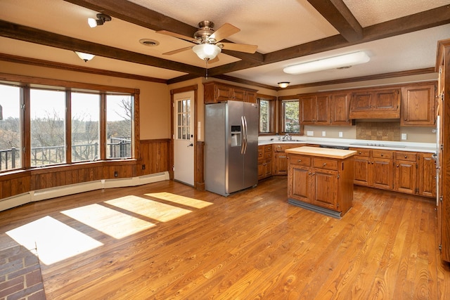 2700 115th St NW, Oronoco, MN 55960 - kitchen featuring brown cabinetry, a kitchen island, ceiling fan, stainless steel fridge, and a sink