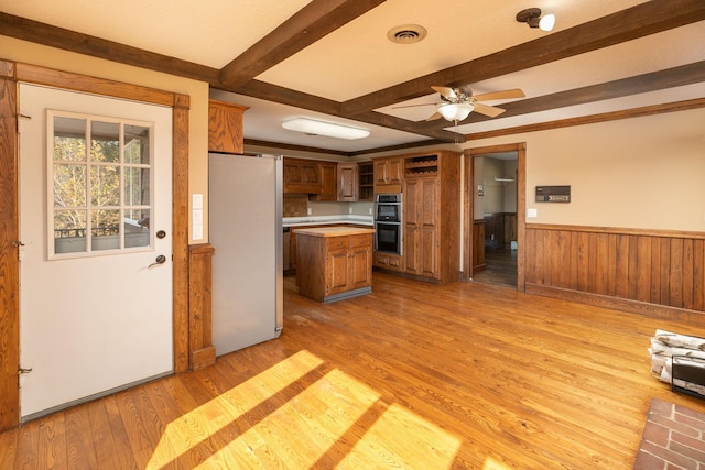 2700 115th St NW, Oronoco, MN 55960 - kitchen with a ceiling fan, brown cabinets, light countertops, freestanding refrigerator, and double oven