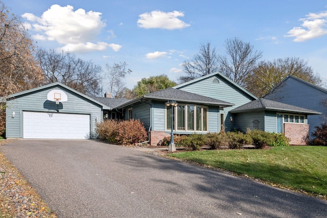 ranch-style house featuring a garage and a front yard