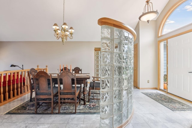 dining area featuring vaulted ceiling and a chandelier