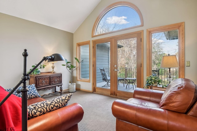 living room with carpet, high vaulted ceiling, and french doors