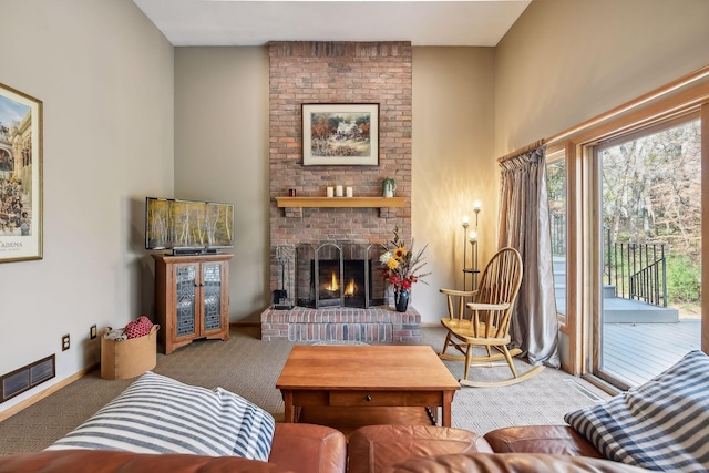 living room with carpet floors and a brick fireplace