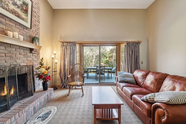 living room with a fireplace and a towering ceiling