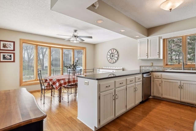 kitchen featuring kitchen peninsula, sink, and plenty of natural light