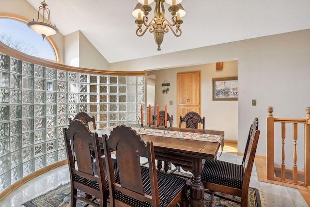 dining room with vaulted ceiling and an inviting chandelier