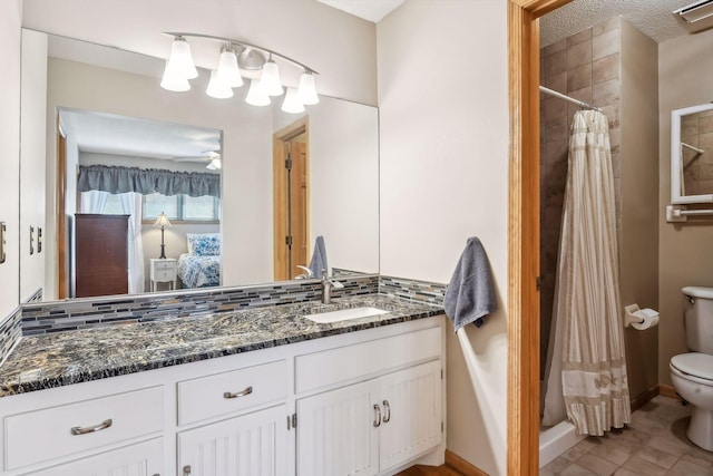 bathroom with tasteful backsplash, walk in shower, vanity, ceiling fan, and toilet