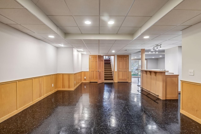 unfurnished room featuring wooden walls